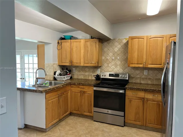 a kitchen with a sink stove and cabinets