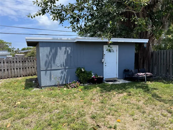 a view of a house with a backyard and porch