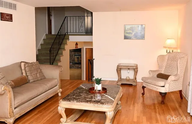 a living room with furniture and a wooden floor