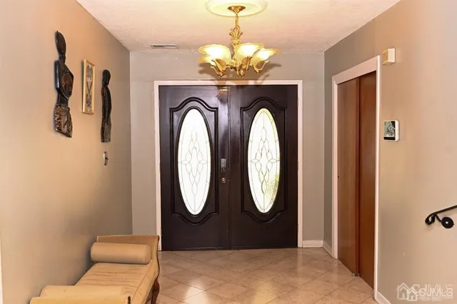 a living room with furniture and a mirror