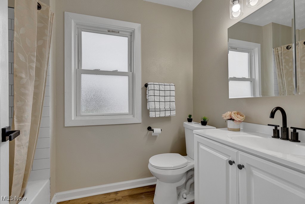 2127 Rossmoor Road Cleveland Heights, OH 44118 - Photo 11 of 21 Full bathroom with baseboards, toilet, vanity, and wood finished floors