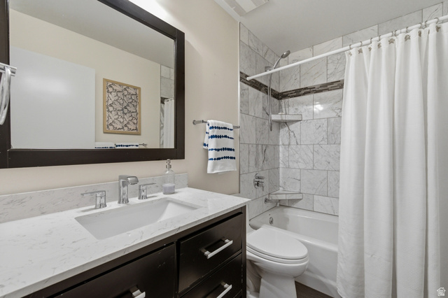 3674 Oak Rim Way Salt Lake City, UT 84109 - Photo 22 of 47 Vanity with an integrated rectangular sink and chrome fixtures, dark wood-finish cabinetry, and a framed mirror