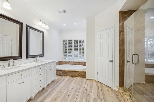 a bathroom with a double vanity sink and mirror with shower