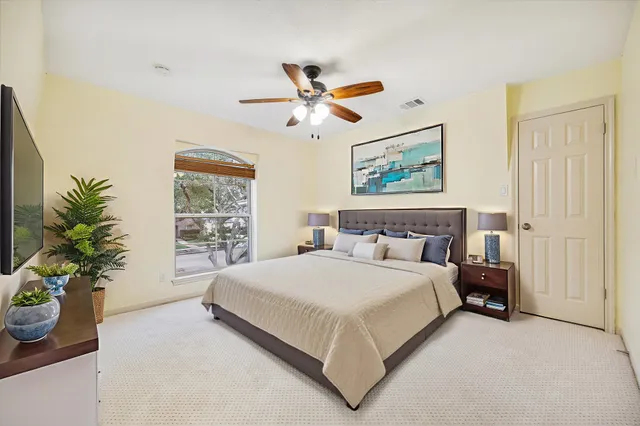 a bedroom with a large bed and a window