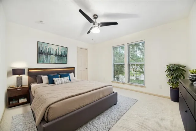 a bedroom with a large bed and a window