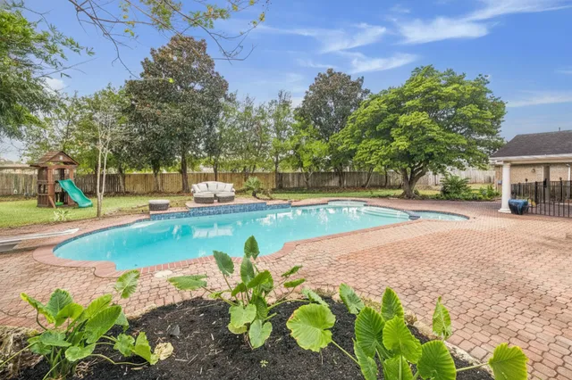 a view of a swimming pool with a yard