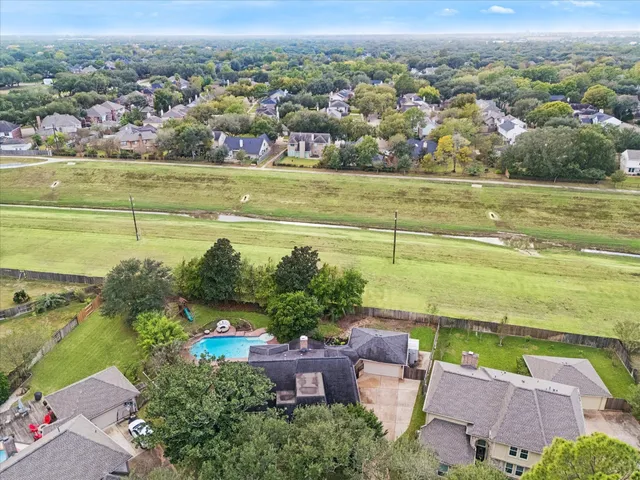 an aerial view of a house with a lake view