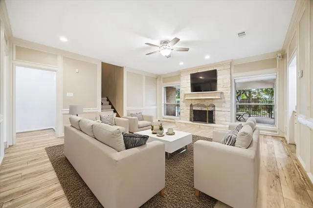a living room with furniture a fireplace and a flat screen tv