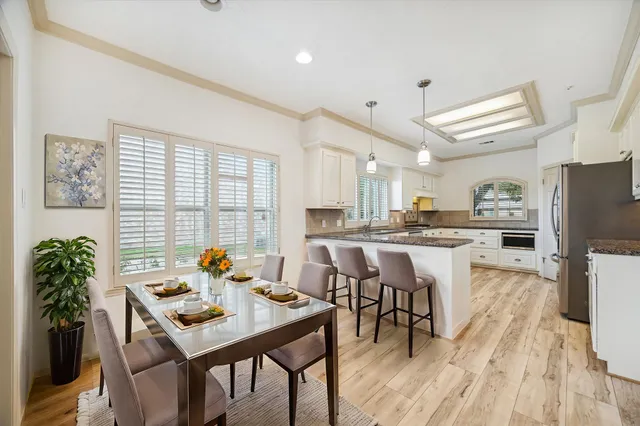 a view of a dining room with furniture and wooden floor
