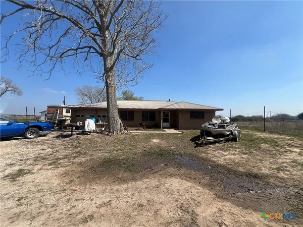 a view of a house with truck parked on a road