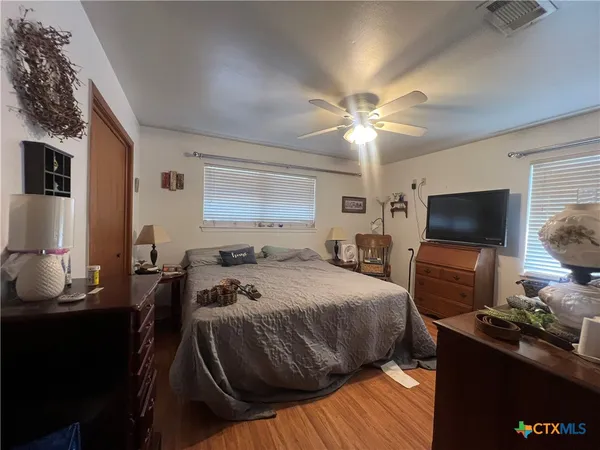 a bedroom with a bed and a flat screen tv