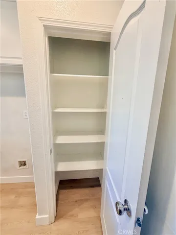 a view of walk in closet with empty racks