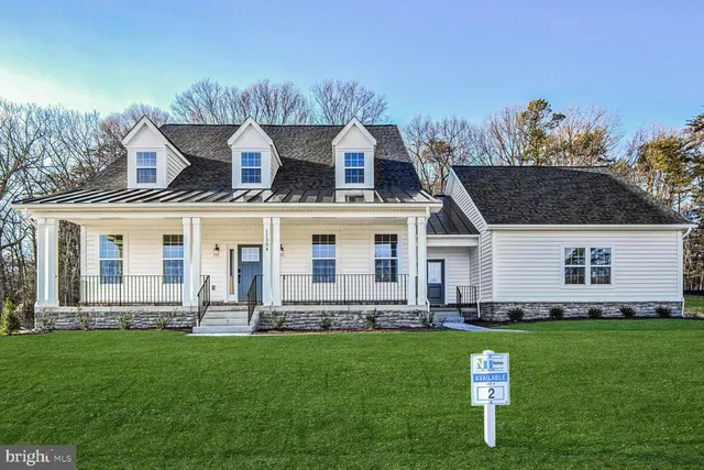 a front view of a house with a garden and yard