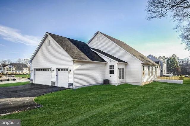 a view of a house with a yard and large trees
