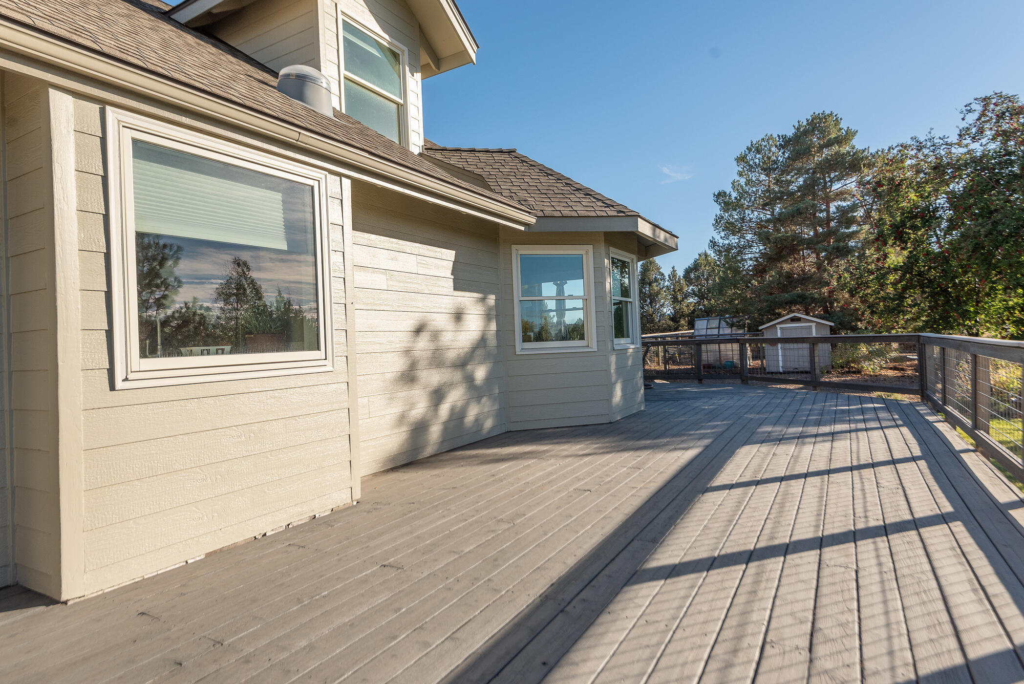 60835 Jennings Road Bend, OR 97702 - Photo 32 of 53 The deck extends from the primary suite and wraps around the breakfast nook where the outdoor table is (out of picture)