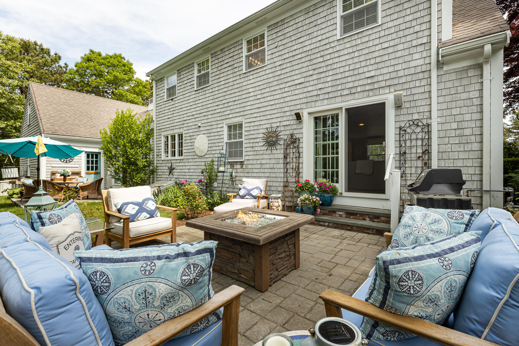 1122 Old Post Road Cotuit, MA 02635 - Photo 19 of 32 a view of a patio with couches table and chairs with wooden fence