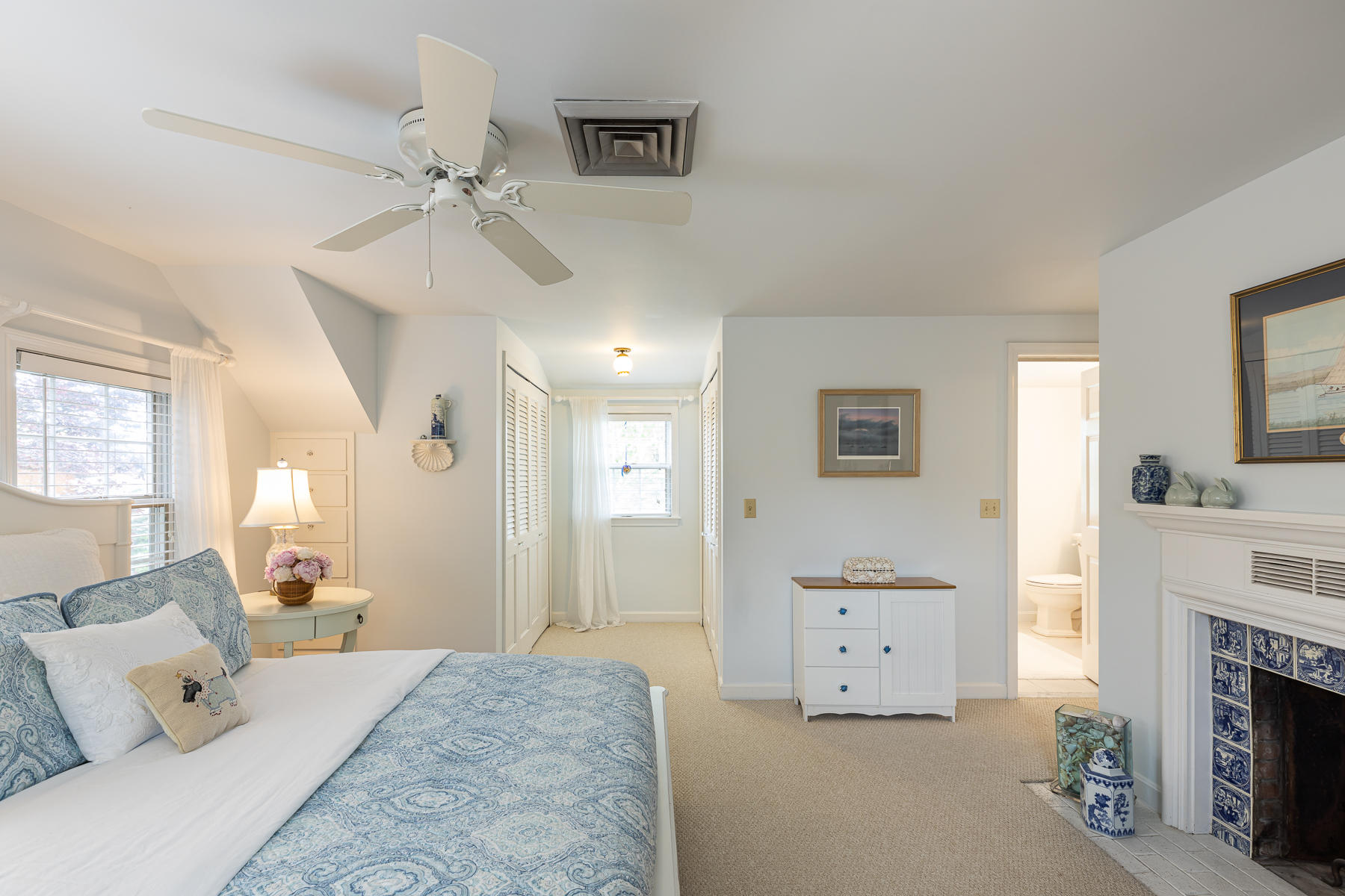 1122 Old Post Road Cotuit, MA 02635 - Photo 22 of 32 a spacious bedroom with a bed and a fireplace