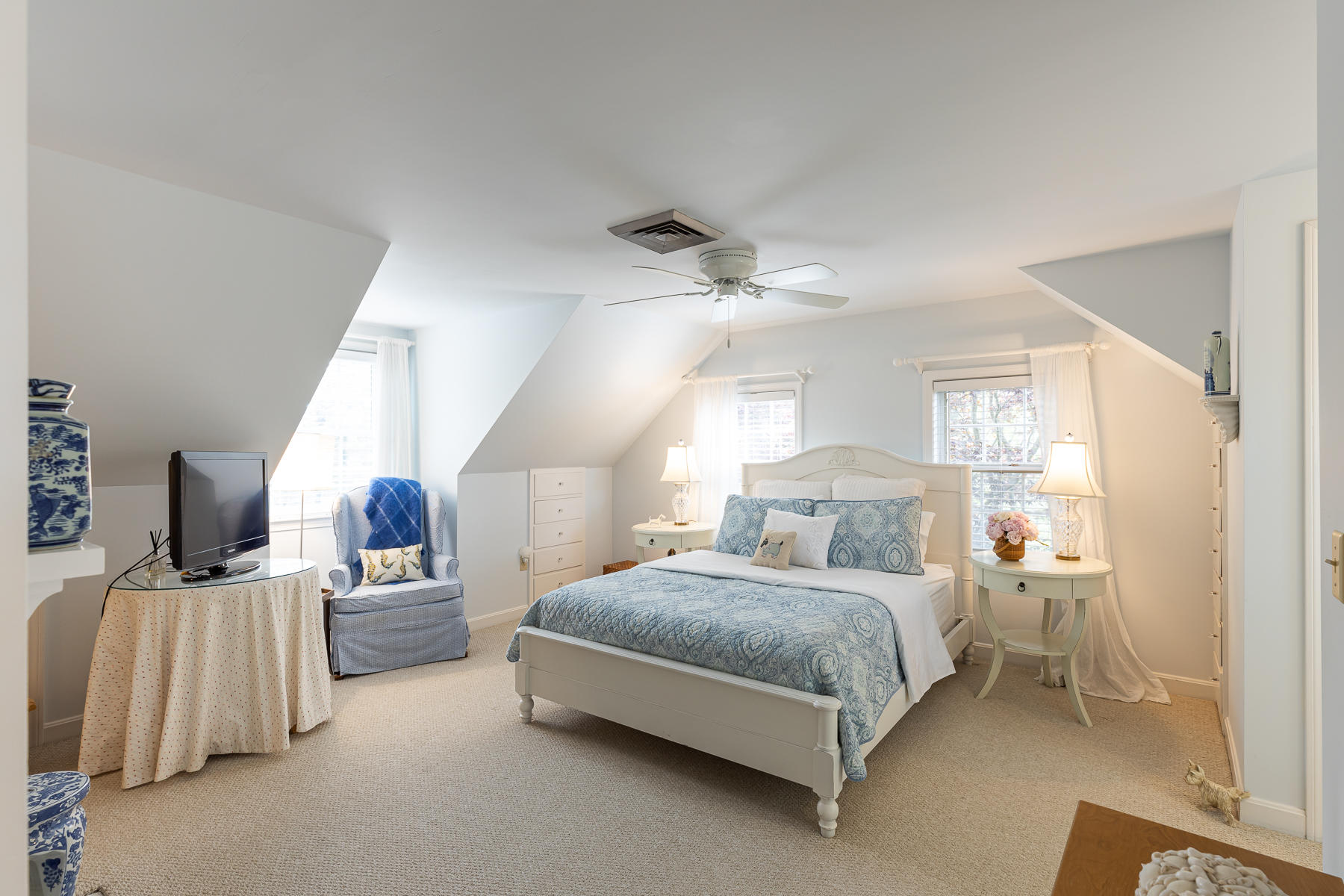 1122 Old Post Road Cotuit, MA 02635 - Photo 23 of 32 a spacious bedroom with a bed and lamp