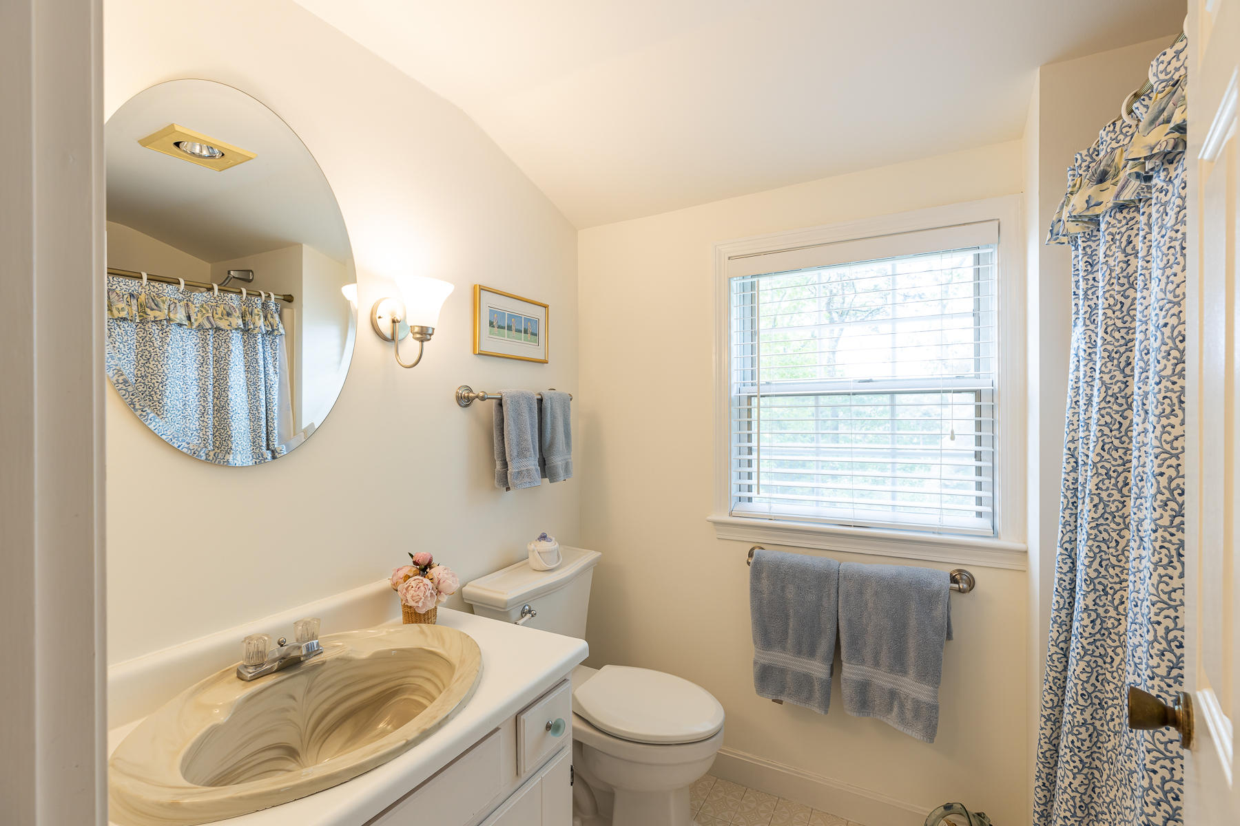 1122 Old Post Road Cotuit, MA 02635 - Photo 27 of 32 a bathroom with a sink a toilet and a mirror