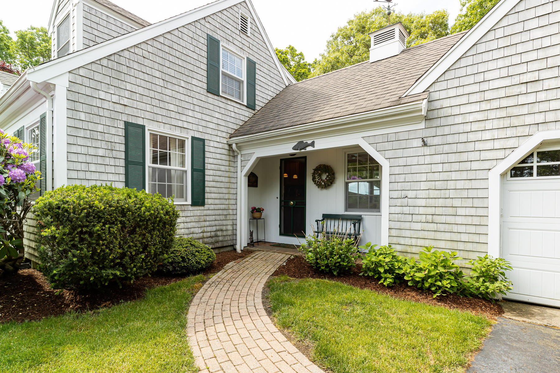 1122 Old Post Road Cotuit, MA 02635 - Photo 6 of 32 a front view of a house with garden