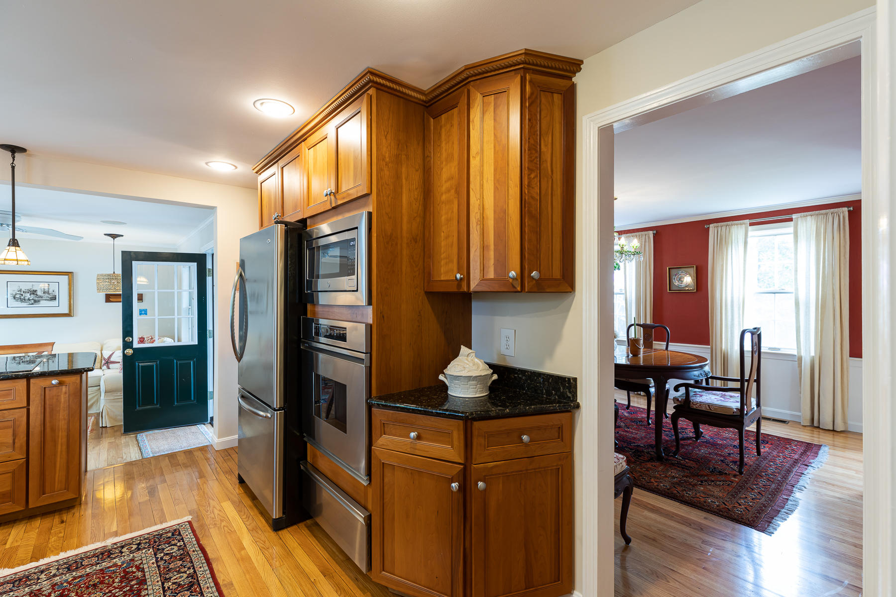 1122 Old Post Road Cotuit, MA 02635 - Photo 10 of 32 a kitchen view with a refrigerator a stove a dining table and chairs with wooden floor