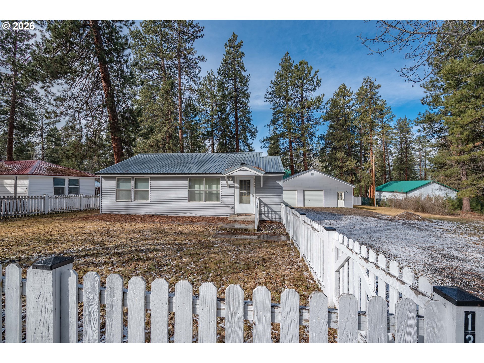 138722 Rhododendron Street Gilchrist, OR 97737 - Photo 14 of 27 a front view of a house with wooden fence
