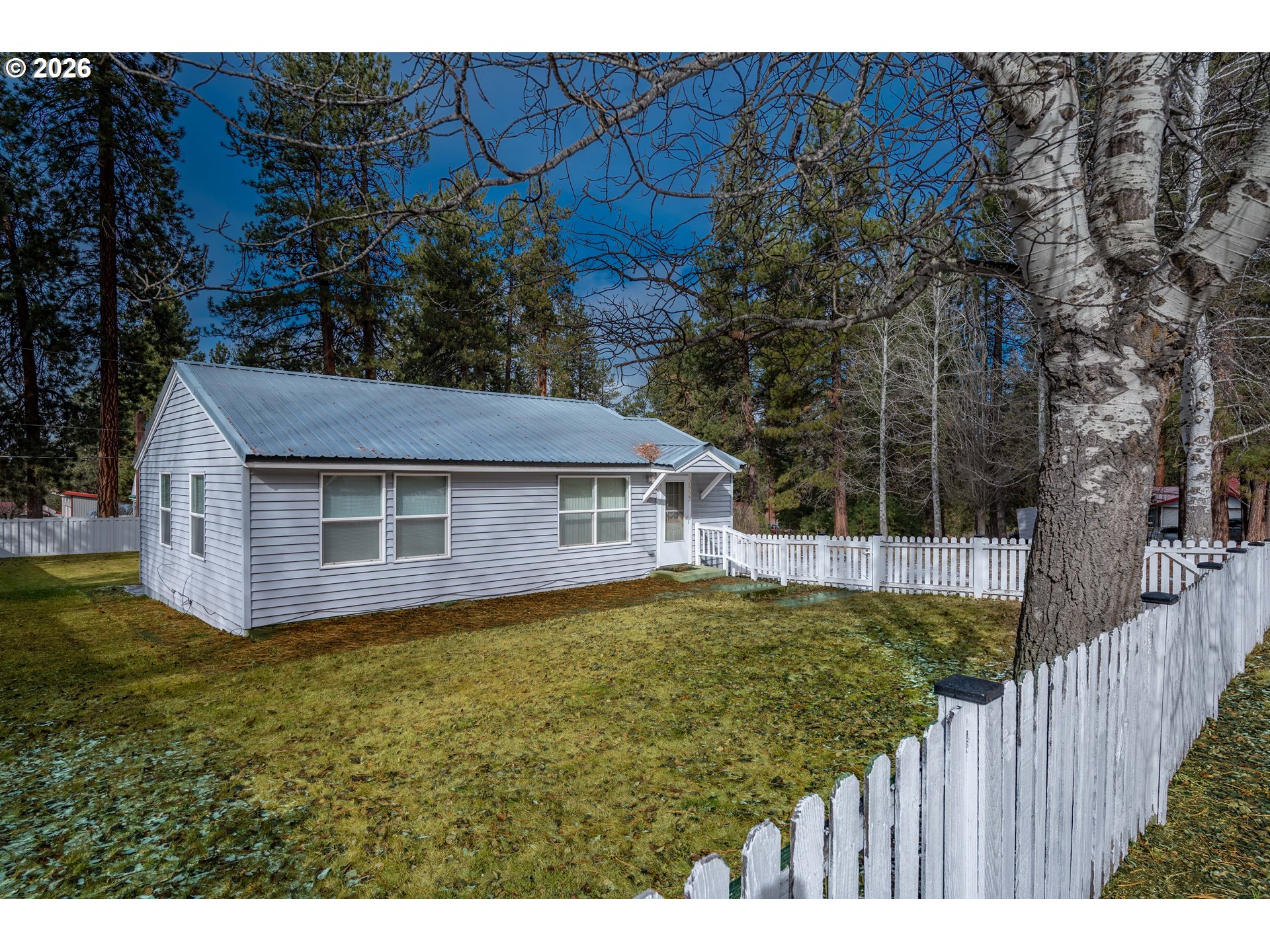 138722 Rhododendron Street Gilchrist, OR 97737 - Photo 16 of 27 a view of a house with wooden fence
