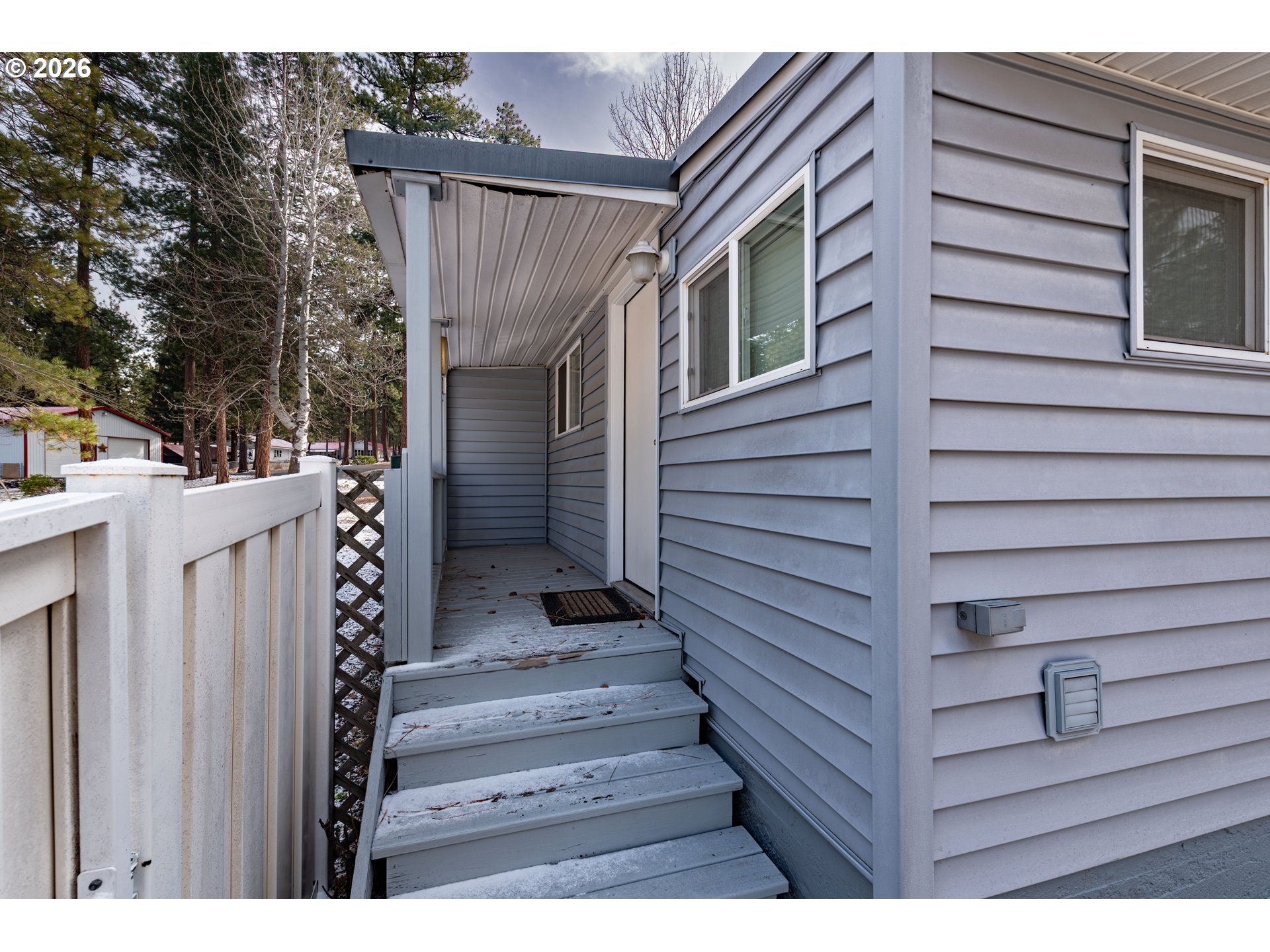 138722 Rhododendron Street Gilchrist, OR 97737 - Photo 3 of 27 a view of wooden house with a door and wooden stairs