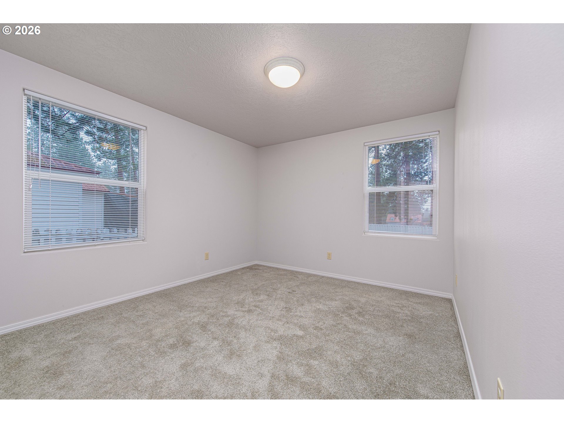 138722 Rhododendron Street Gilchrist, OR 97737 - Photo 9 of 27 a view of an empty room with a window