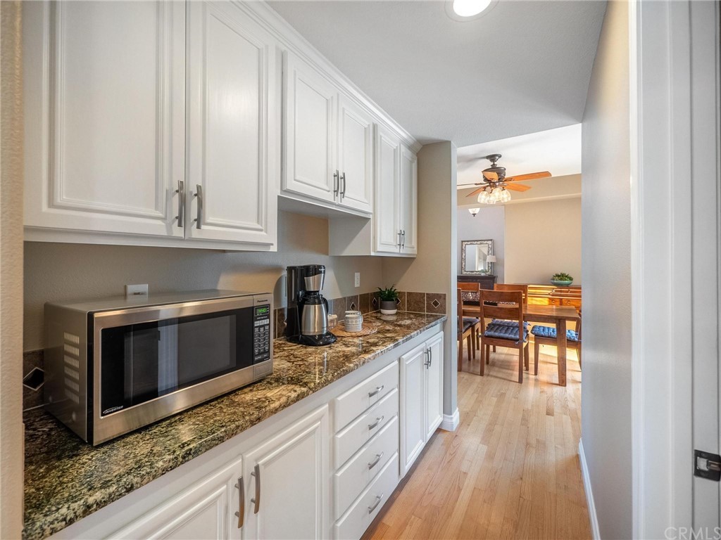2 Whippoorwill Road Trabuco Canyon, CA 92679 - Photo 24 of 57 a kitchen with granite countertop a stove a sink and a microwave