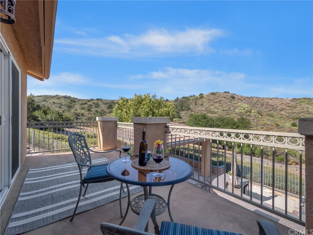 2 Whippoorwill Road Trabuco Canyon, CA 92679 - Photo 26 of 57 a view of a balcony with two chairs and a table
