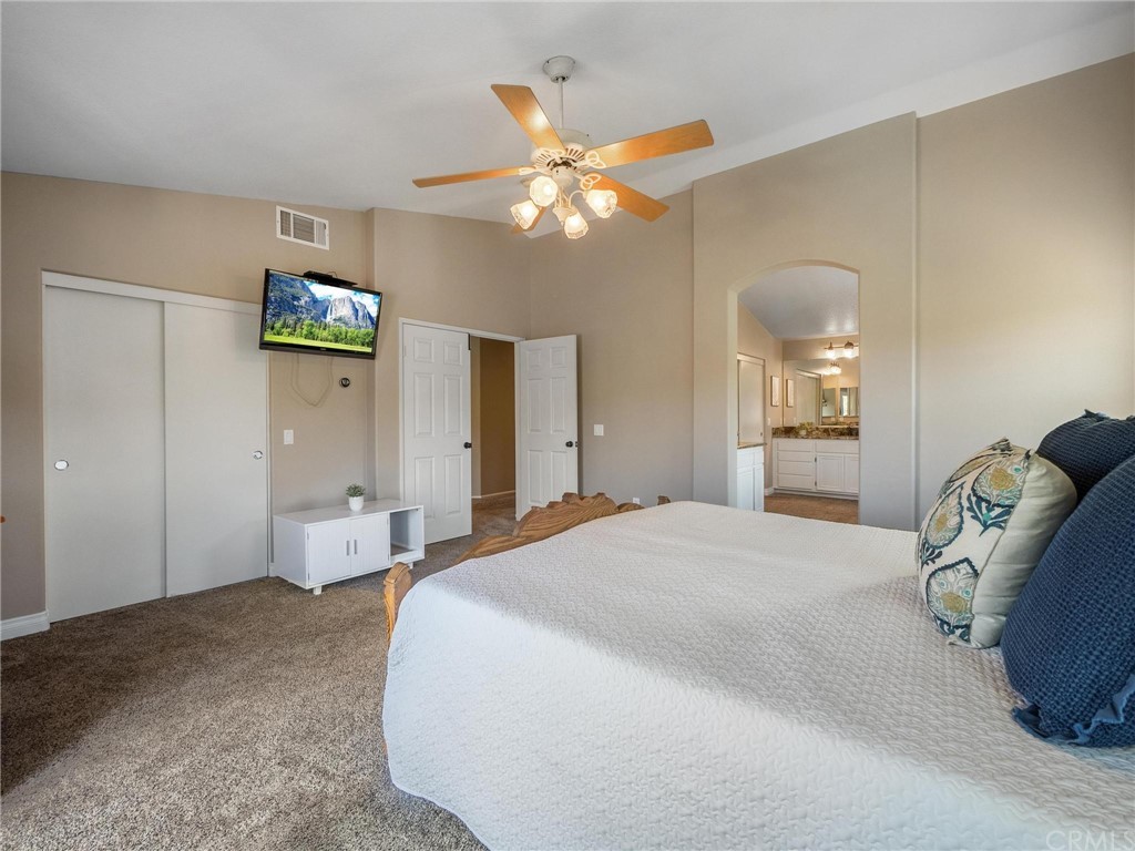 2 Whippoorwill Road Trabuco Canyon, CA 92679 - Photo 29 of 57 a bedroom with a bed and a chandelier