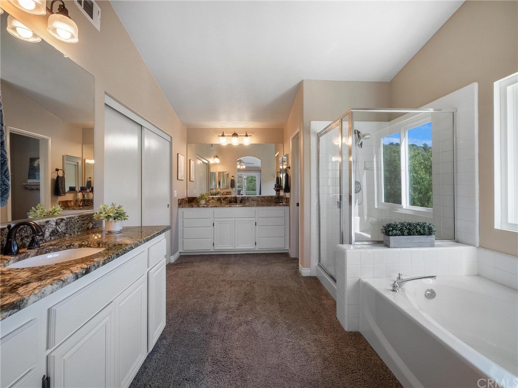 2 Whippoorwill Road Trabuco Canyon, CA 92679 - Photo 31 of 57 a large bathroom with a large tub sink shower and mirror