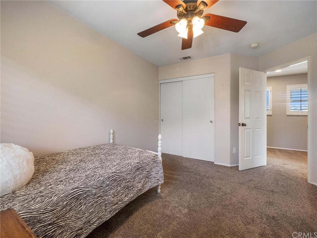 2 Whippoorwill Road Trabuco Canyon, CA 92679 - Photo 40 of 57 a bedroom with a bed and a chandelier fan