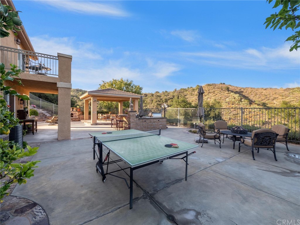 2 Whippoorwill Road Trabuco Canyon, CA 92679 - Photo 7 of 57 a view of a patio with dining table and chairs with a small yard