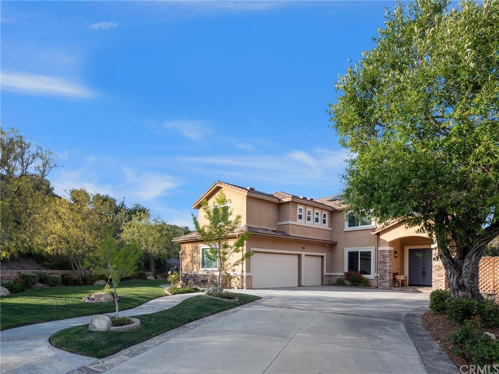 2 Whippoorwill Road Trabuco Canyon, CA 92679 - Photo 9 of 57 a front view of a house with a garden and trees
