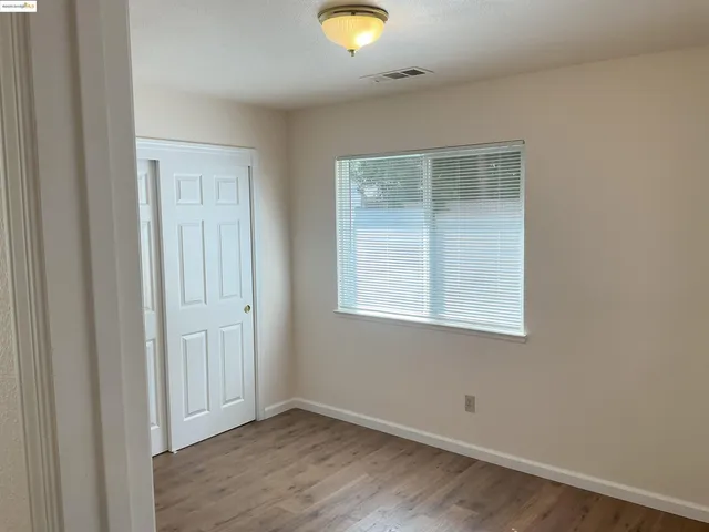 an empty room with closet and window