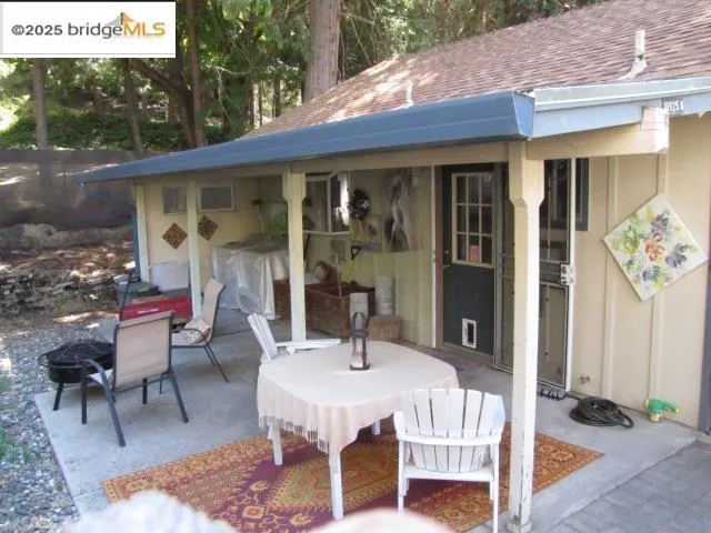 a front view of a house with outdoor seating