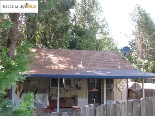 a couple of table and chairs in front of house