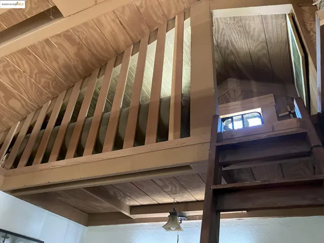a view of staircase with wooden floor and chair