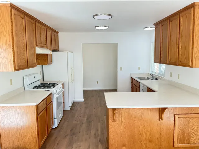 a kitchen with a sink stove and refrigerator