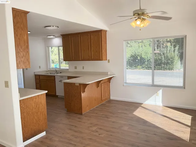 a kitchen with a sink cabinets and window
