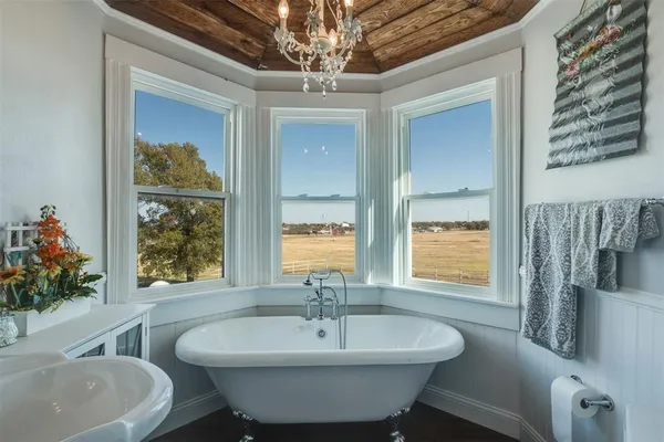 a spacious bathroom with a sink and a large mirror