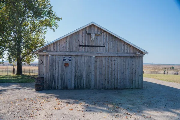 a wooden house with a wooden fence