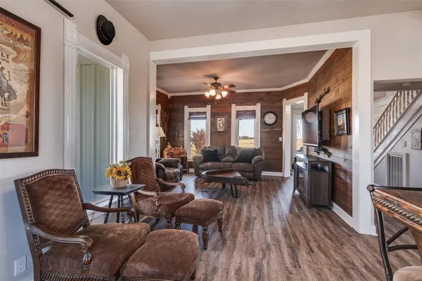 a living room with furniture and wooden floor