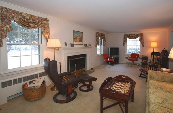 57 Emerson Road Wellesley, MA 02481 - Photo 5 of 9 a living room with furniture a window and a fireplace