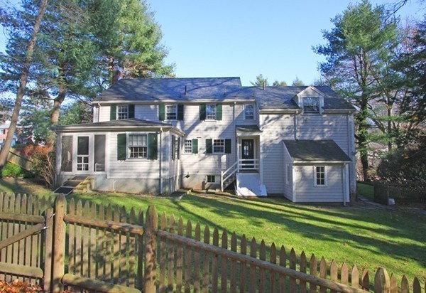 57 Emerson Road Wellesley, MA 02481 - Photo 8 of 9 a front view of a house with a yard table and chairs