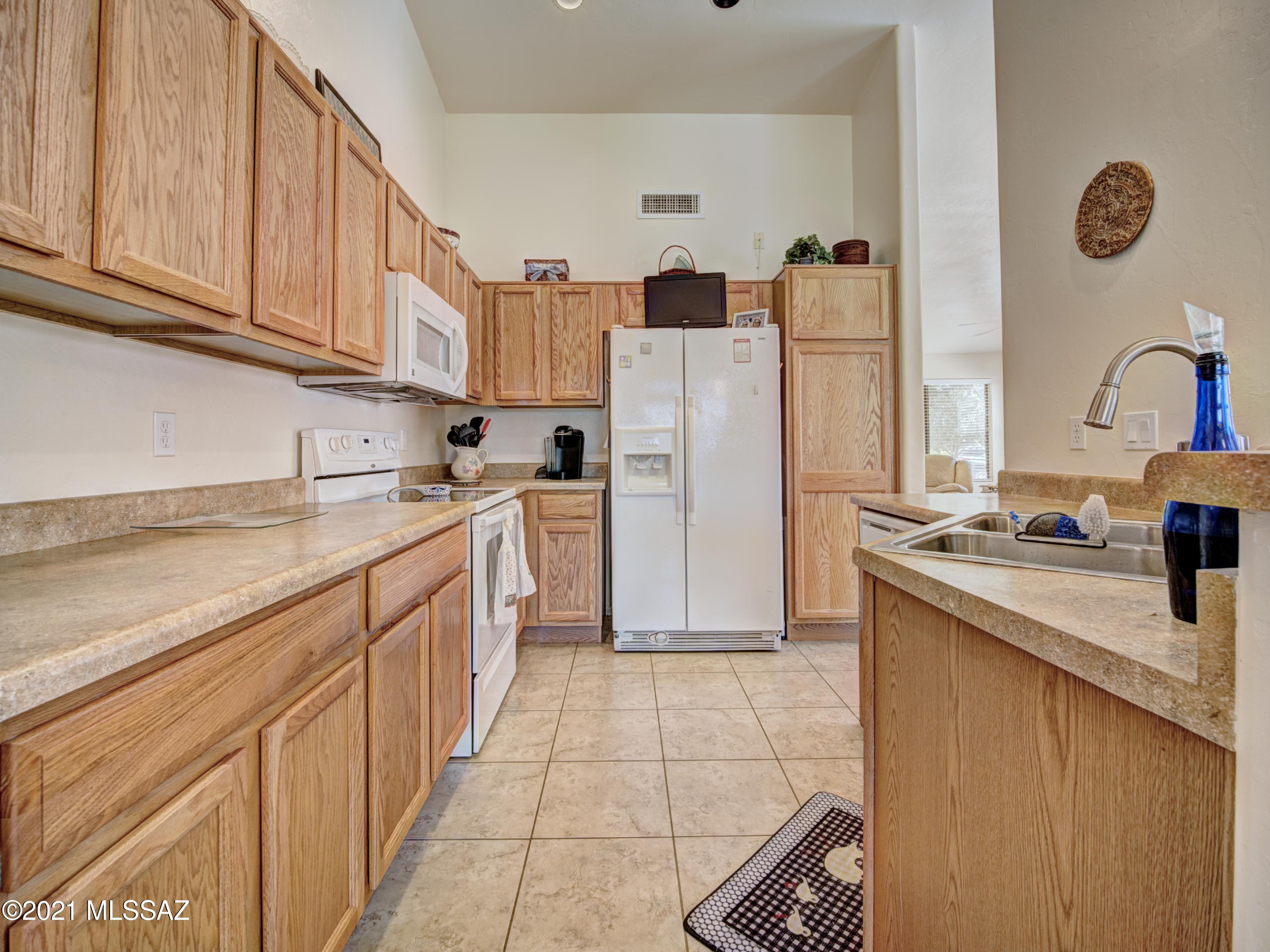 434 Colorado Court Rio Rico, AZ 85648 - Photo 15 of 29 a kitchen with stainless steel appliances granite countertop a sink and a refrigerator
