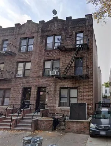 a front view of a building with parking space