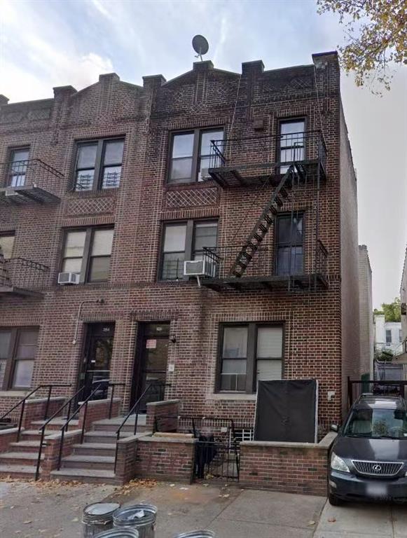 a front view of a building with parking space